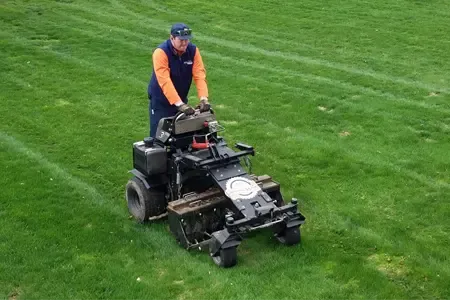 lawn technician aerating lawn