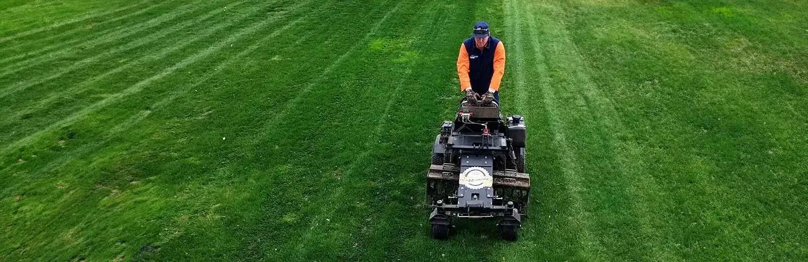 Technician fertilizing lawn