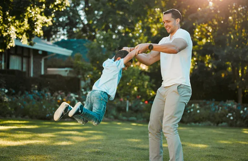 dad and son playing outside